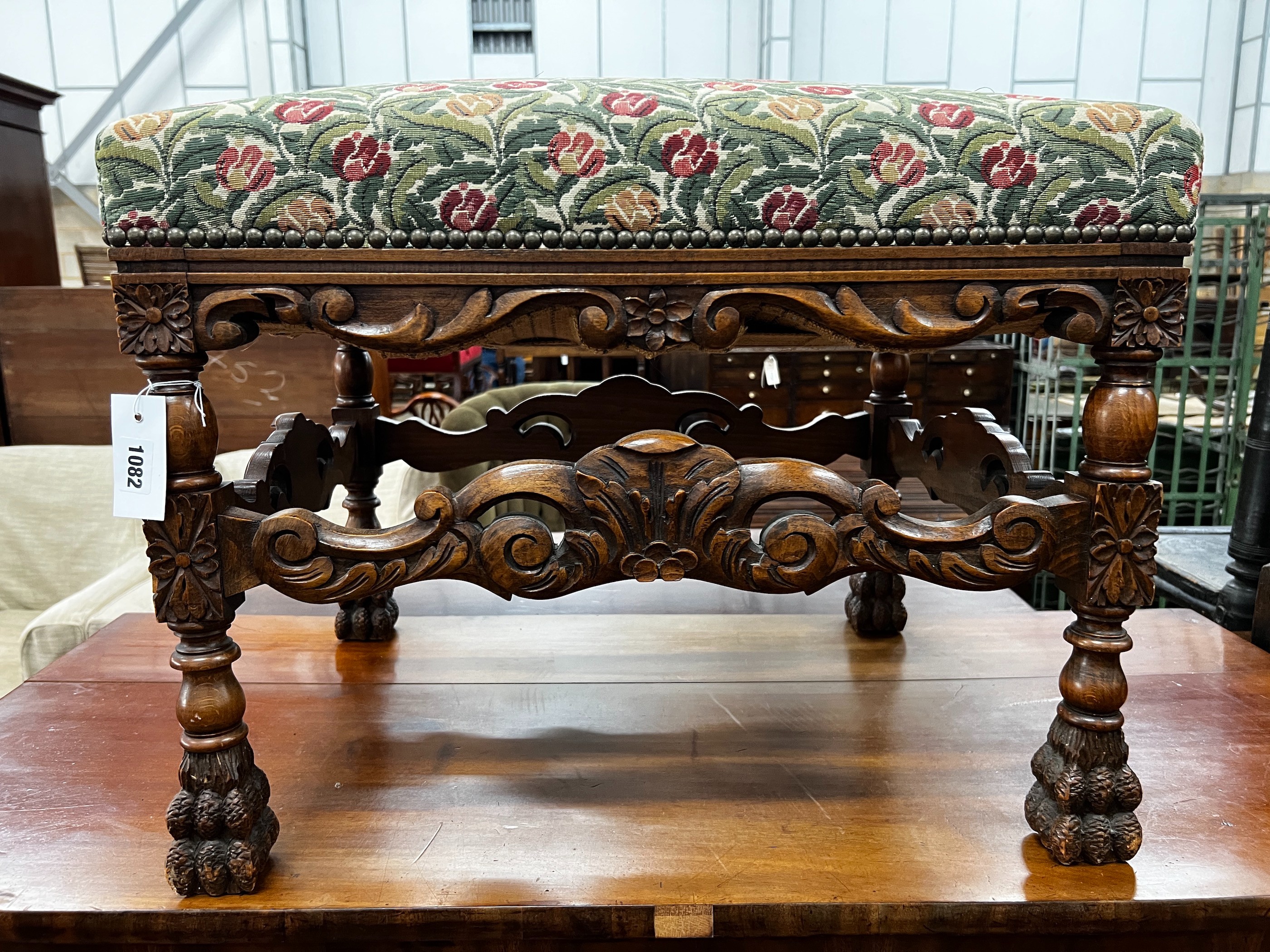 An early 20th century Jacobean revival carved beech dressing stool, length 60cm, depth 48cm, height 49cm